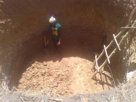 Excavating one of two septic tanks.